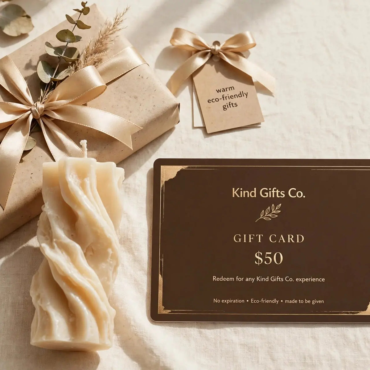 Kind Gifts Co. Gift Card with a sculptural candle and wrapped gift box