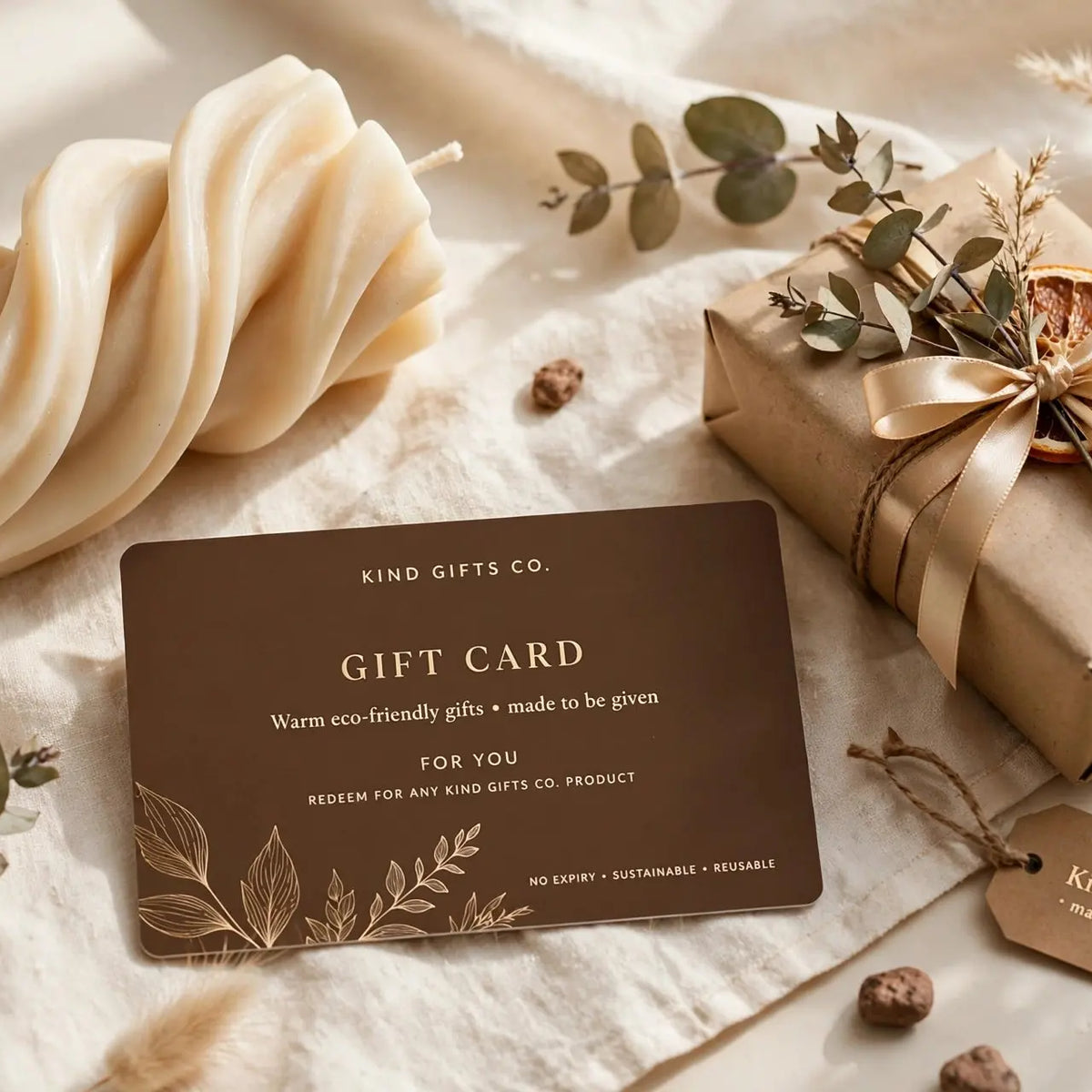 Kind Gifts Co. Gift Card flat lay with a twisted sculptural candle and gift box