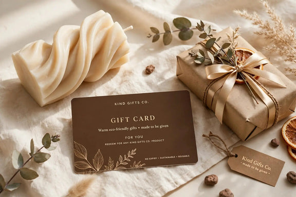 Kind Gifts Co. Gift Card flat lay with a twisted sculptural candle and gift box