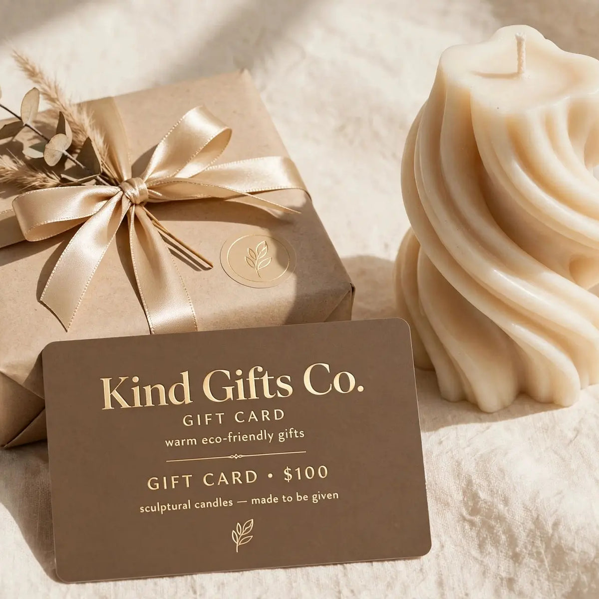 Kind Gifts Co. Gift Card with a sculptural swirl candle and ribbon-tied gift box