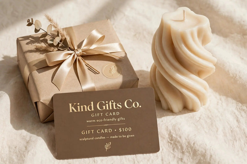 Kind Gifts Co. Gift Card with a sculptural swirl candle and ribbon-tied gift box